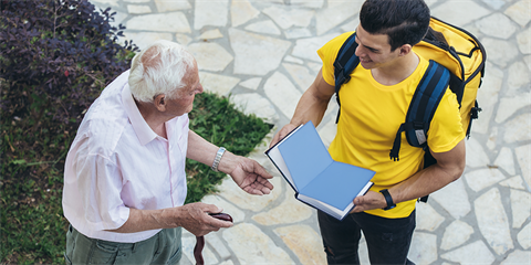 Book being given to elderly man