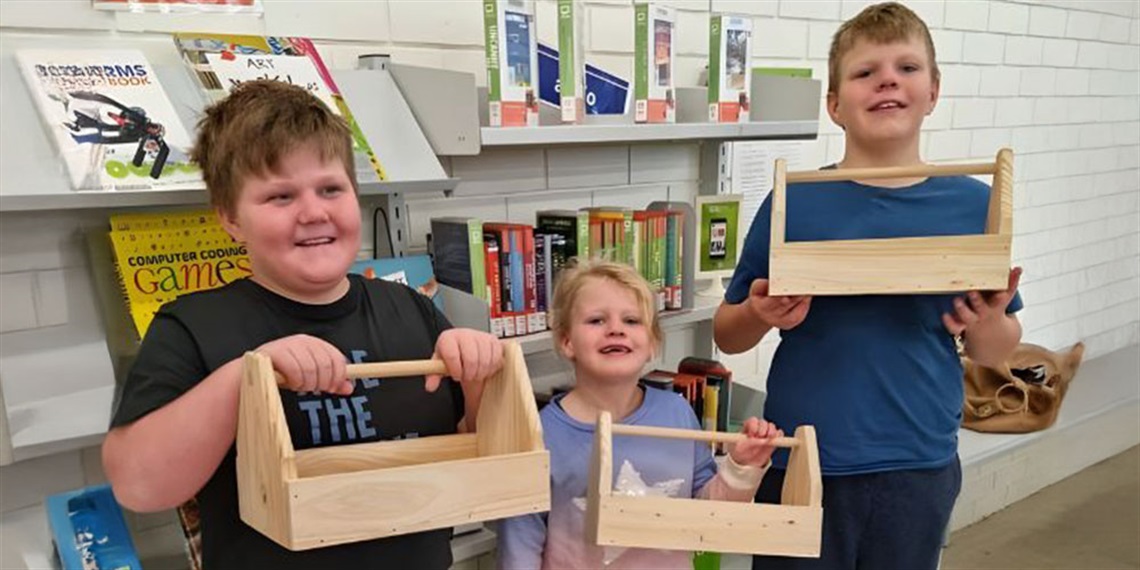 Kids holding a hand made toolbox