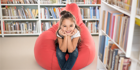 Young girl on a beanbag in the library